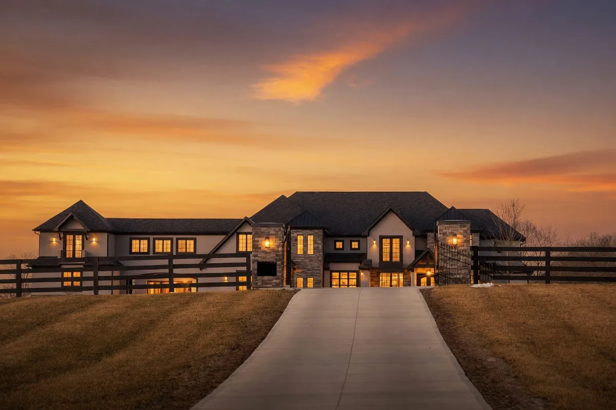 Luxury estate, dramatic sunset elevation — Colorado Springs / Castle Rock area. Luxury build, Custom shapes, Andersen E-Series.